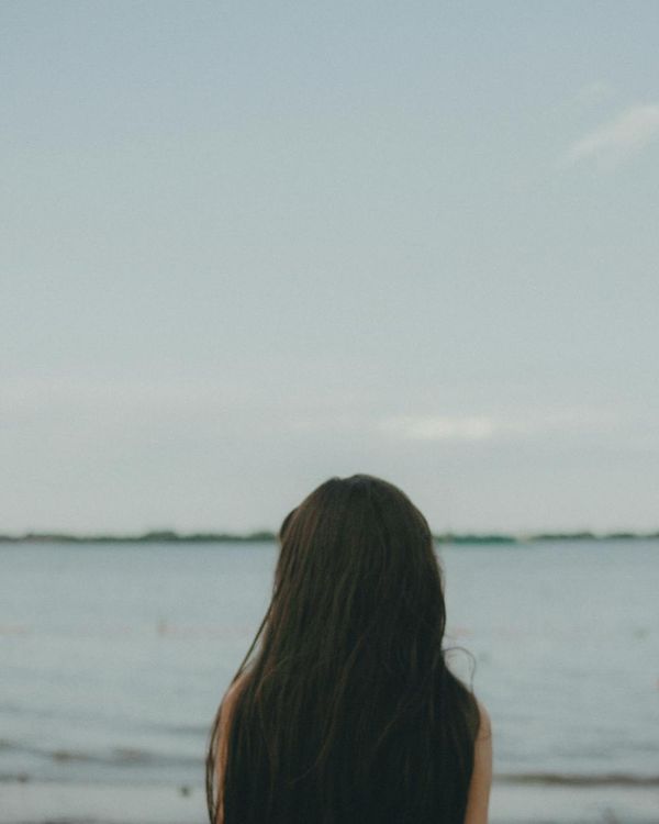 Woman feeling serene and energetic in a bright, open space.